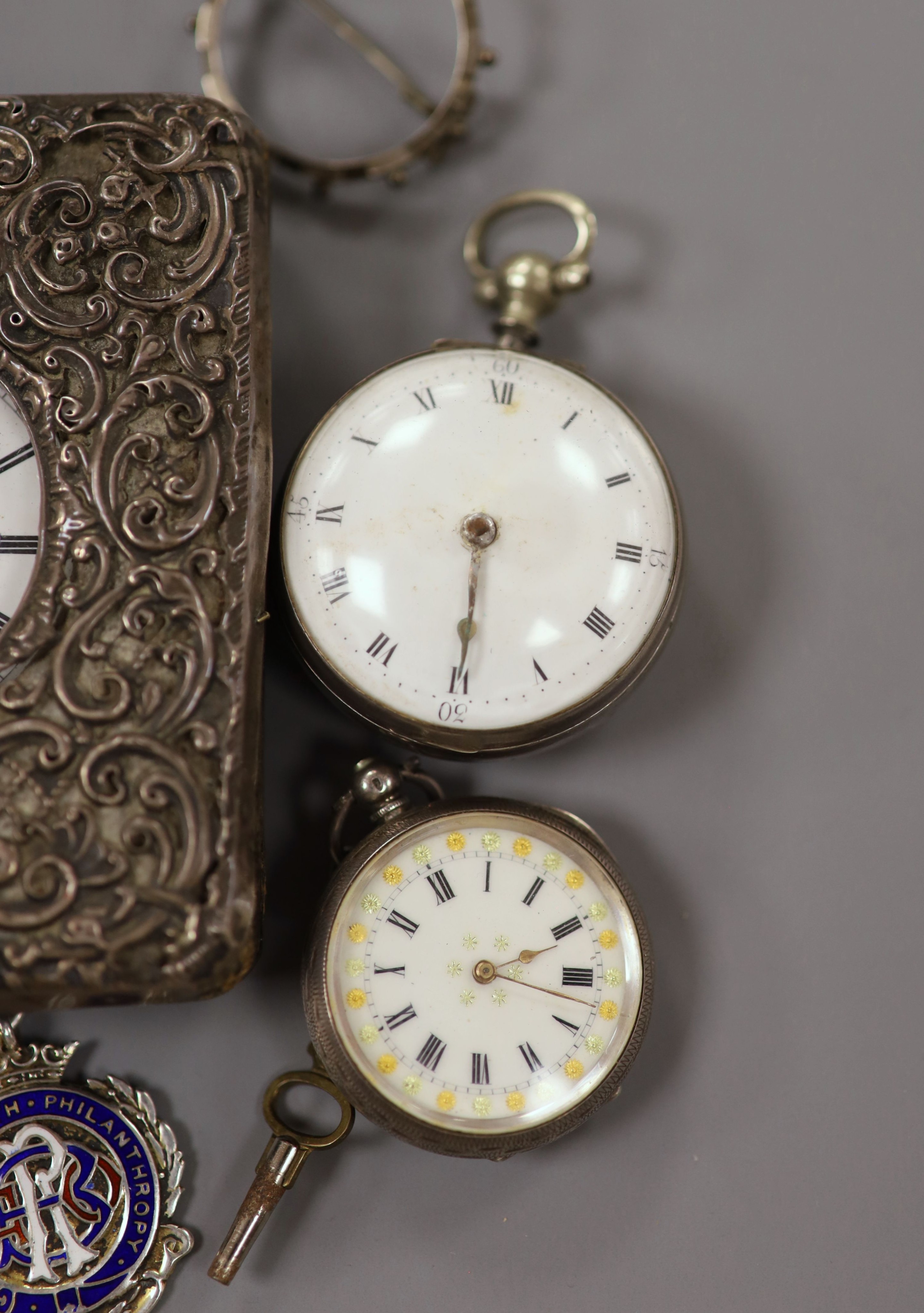 Part of a George III silver pair cased verge pocket watch, A Swiss silver cased travelling watch, five other pocket watches including one in silver mounted travelling case and one with silver albert and two mounted coins